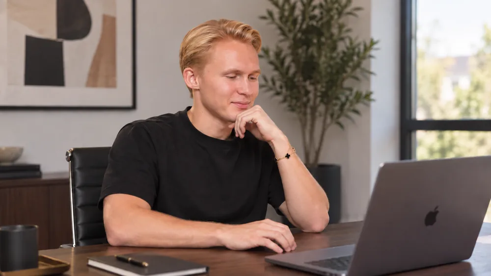 Leo studying a faceless YouTube niche on his laptop